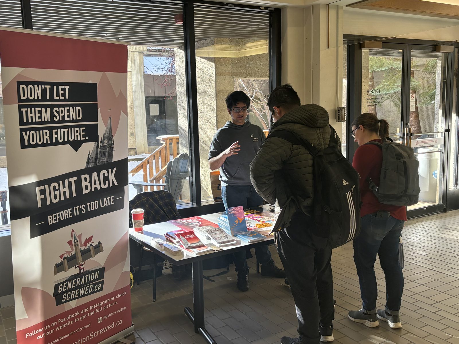 Generation Screwed campus booth with "Fight Back" banners