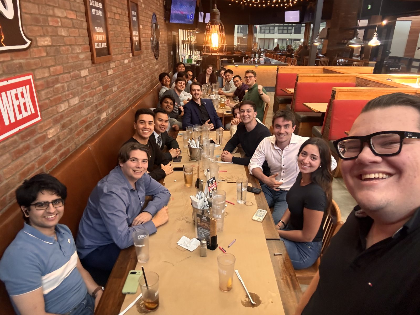 Generation Screwed members gathered around a table at a social night